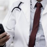 doctor_with_phone_HsYpV8rklT